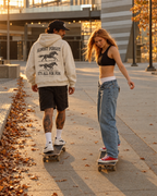 All for Fun hoodie horse artwork worn while skating on an autumn city sidewalk