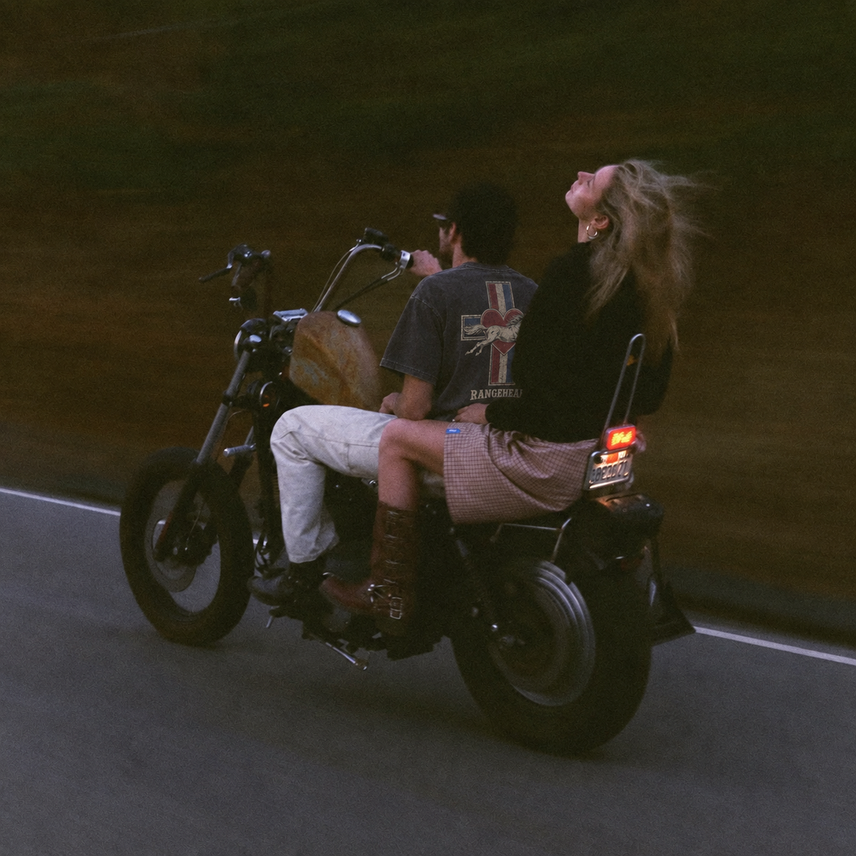 Cross Heart tee worn on a motorcycle at dusk