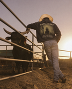 Feel the Fear hoodie back graphic beside a cattle pen