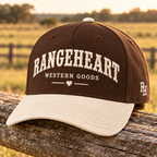 Western Goods Cap in Espresso / cream — in golden sunlight