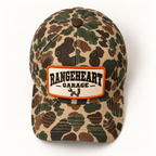 Garage Cap in Woodland camo / orange — overhead view