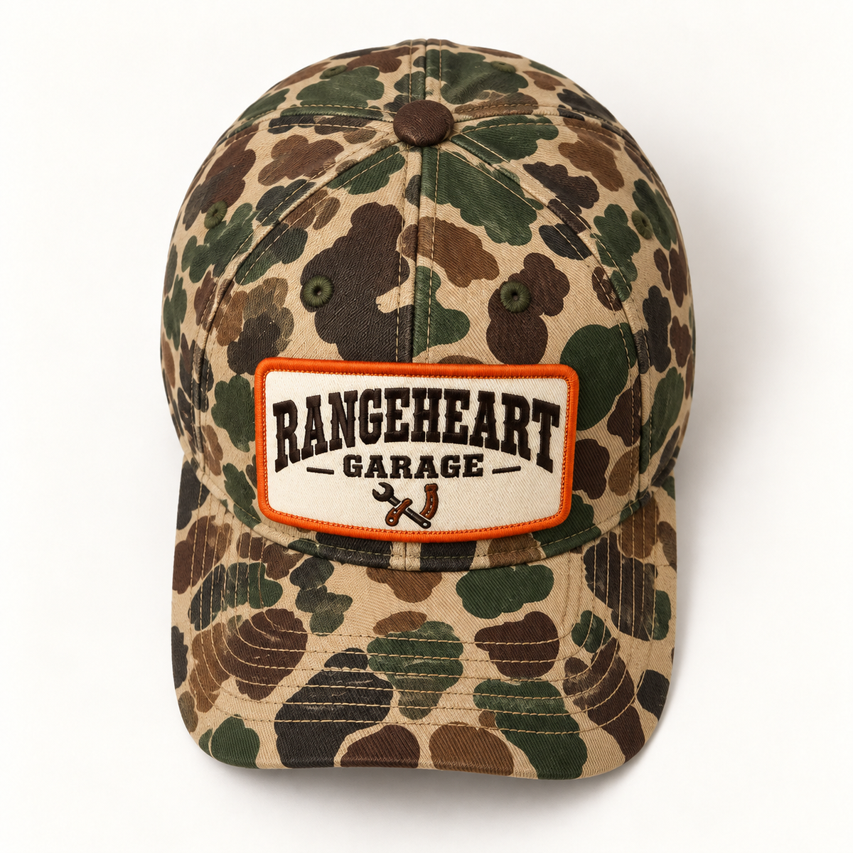 Garage Cap in Woodland camo / orange — overhead view